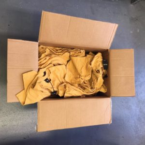 Box of messy t-shirts without folding and bagging